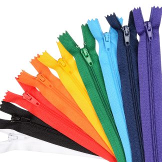 Zippers lined in a row in the manner of the rainbow. Isolated on white